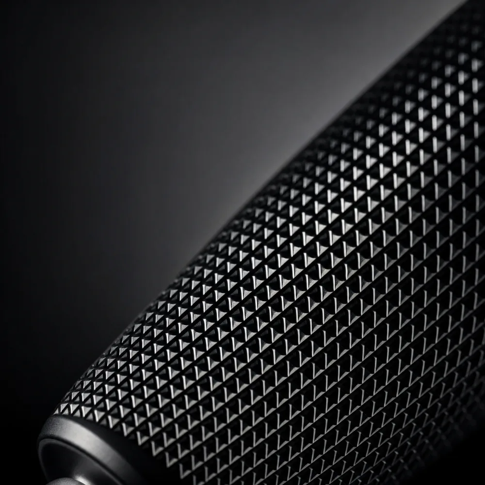 Macro detail shot of a product's texture and material under dramatic studio lighting